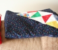 I decided a very simple border was needed. I wanted to blend all the different fabric colors but not detract from the individual squares. I ended up choosing the blue over the red fabric.