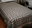 I started my very first quilt using a basket weave design. It was supposedly simple to put together. The majority of the seems didn't line up and I used a dark colored backing with light colored thread. Ooops...every crooked stitch shows.